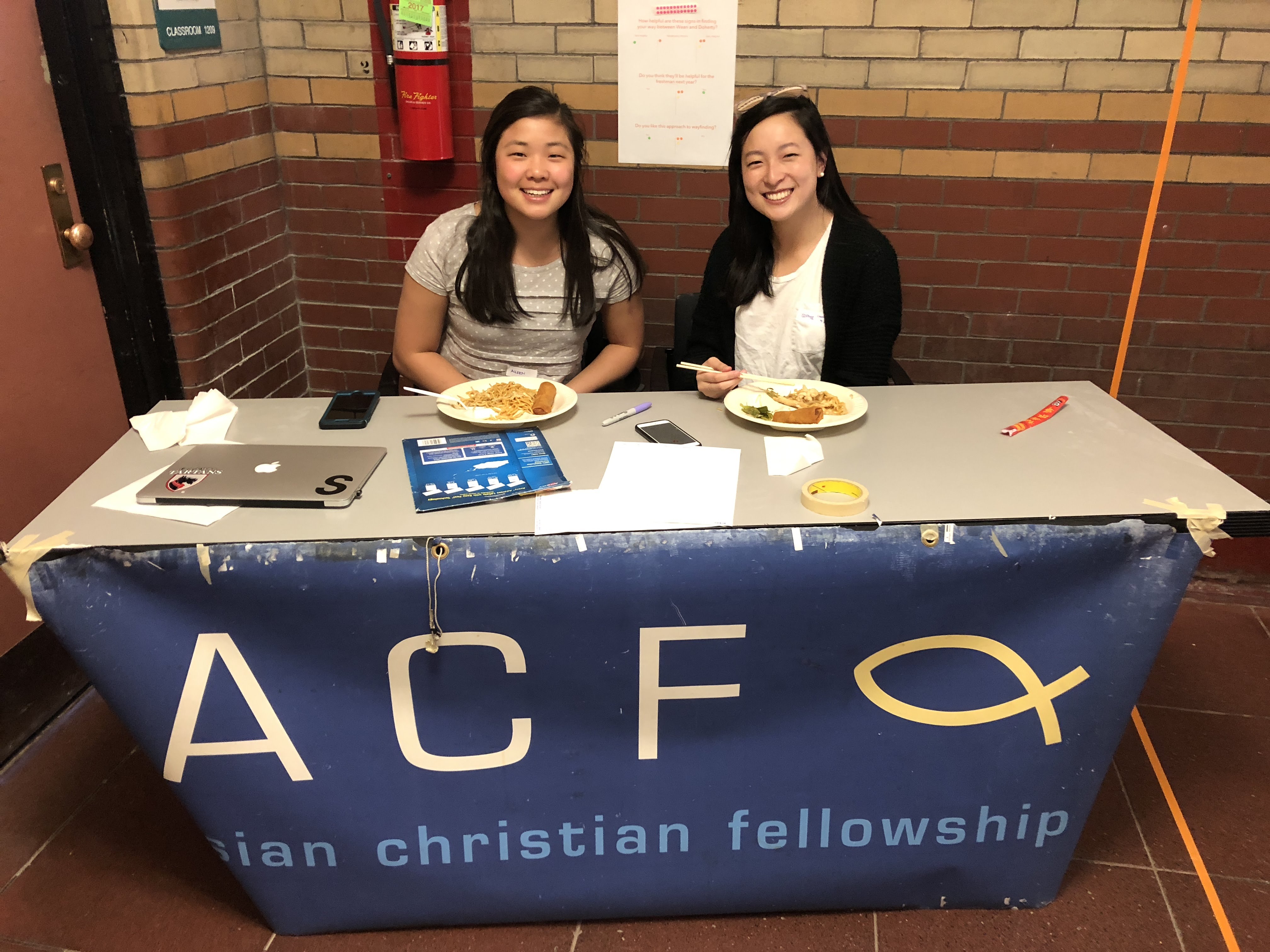 Smiling faces await at the welcome table.